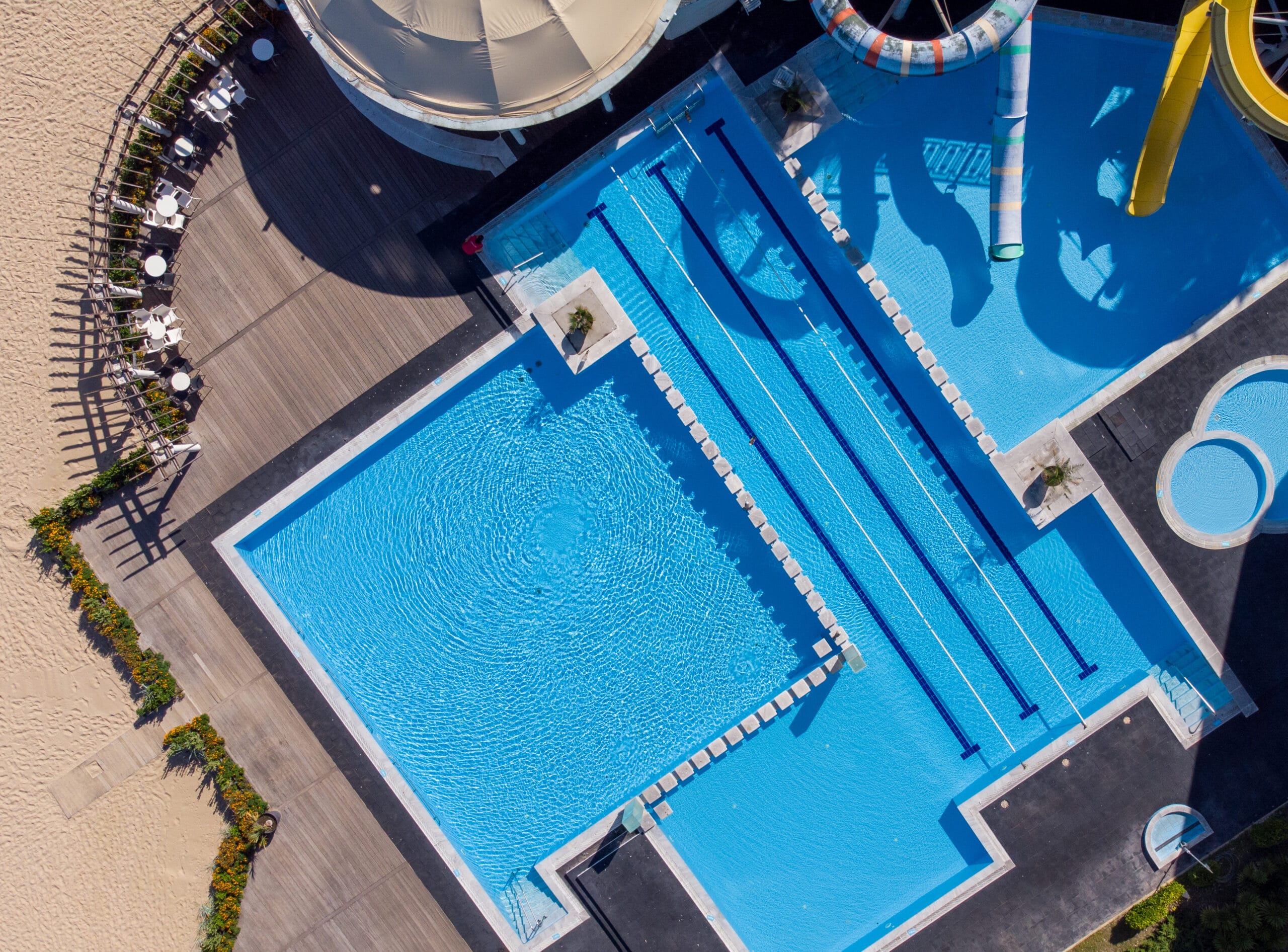 Aerial view of a swimming pool surrounded by lush greenery in a luxury hotel, related to home renovations Tampa FL.