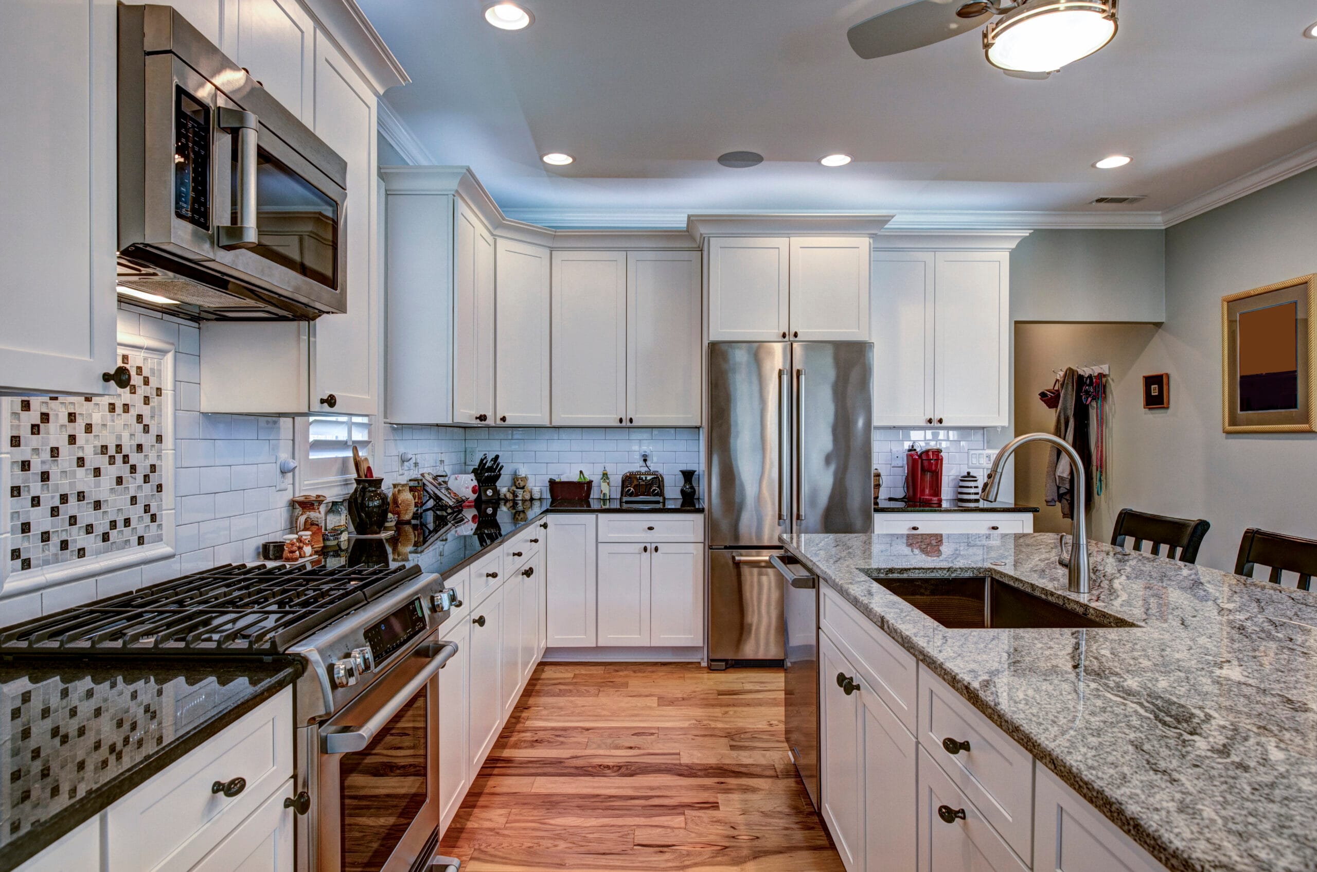 High-end luxury kitchen featuring granite countertops and white cabinets, ideal for home renovations Tampa FL.